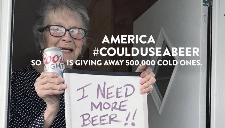Olive Veronesi celebrates getting a stash of Coors Light with a sign that says, "Got More Beer!"