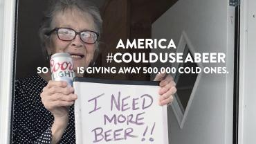 Olive Veronesi celebrates getting a stash of Coors Light with a sign that says, "Got More Beer!"